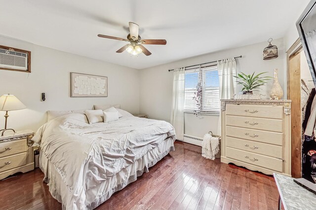 8404 N Greenwood Ave, Niles, IL 60714 - bedroom with dark wood-type flooring, a baseboard radiator, a wall mounted AC, ceiling fan, and baseboards
