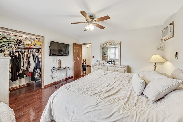 8404 N Greenwood Ave, Niles, IL 60714 - bedroom with wood finished floors, a walk in closet, a closet, an AC wall unit, and a ceiling fan