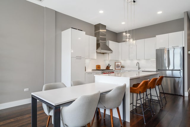 1120 W Adams St Unit 5W, Chicago, IL 60607 - kitchen featuring freestanding refrigerator, wall chimney range hood, a sink, modern cabinets, and dark wood-style flooring