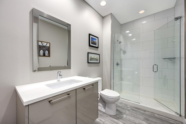 1120 W Adams St Unit 5W, Chicago, IL 60607 - full bathroom featuring a stall shower, toilet, vanity, wood finished floors, and recessed lighting