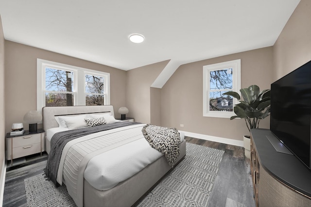 bedroom with baseboards and dark wood-style flooring