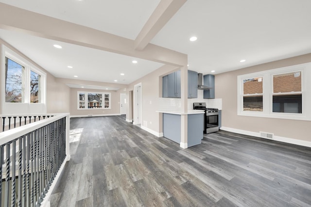 unfurnished living room featuring dark wood-style flooring, baseboards, and recessed lighting