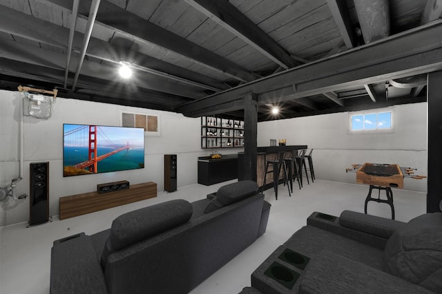 living area with concrete flooring and bar