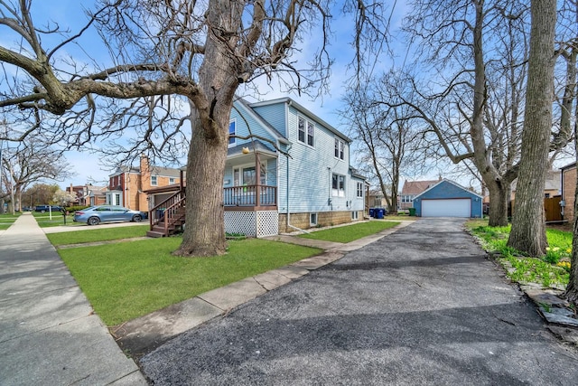 view of property exterior featuring a residential view, a garage, a yard, and an outbuilding