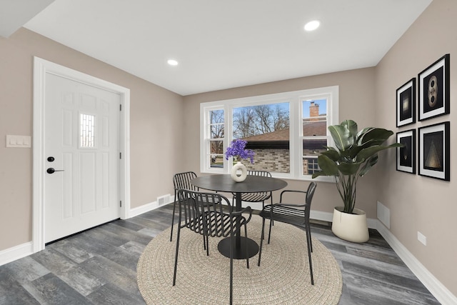 dining space featuring baseboards, wood finished floors, and recessed lighting