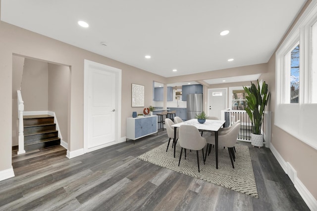 dining room featuring dark wood-type flooring, baseboards, stairs, and recessed lighting
