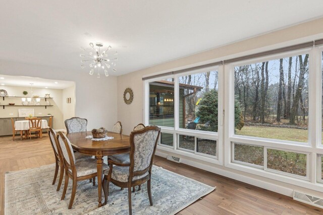 32225 N Pine Ave, Grayslake, IL 60030 - dining area with a chandelier, healthy amount of natural light, and wood finished floors