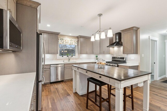 32225 N Pine Ave, Grayslake, IL 60030 - kitchen featuring stainless steel appliances, wall chimney exhaust hood, wood finished floors, light countertops, and recessed lighting