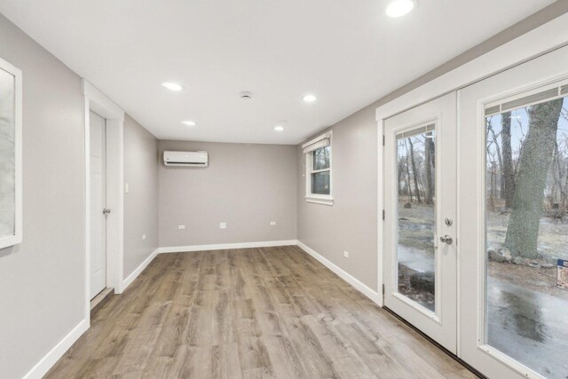 32225 N Pine Ave, Grayslake, IL 60030 - unfurnished room with a wall unit AC, recessed lighting, light wood finished floors, baseboards, and plenty of natural light