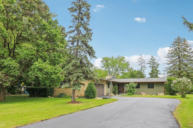 32225 N Pine Ave, Grayslake, IL 60030 - view of front facade with a garage, driveway, a front yard, and a playground