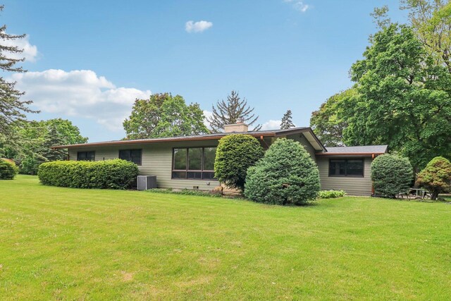32225 N Pine Ave, Grayslake, IL 60030 - view of front facade featuring a front lawn, central AC unit, and a chimney