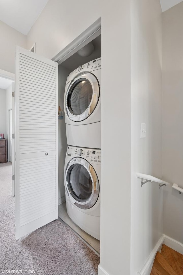 51 E 23rd St Unit 0, Chicago, IL 60616 - laundry area with estacked washer and dryer and baseboards