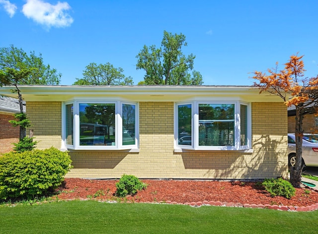 8619 Crawford Ave, Skokie, IL 60076 - view of property exterior with brick siding and a lawn