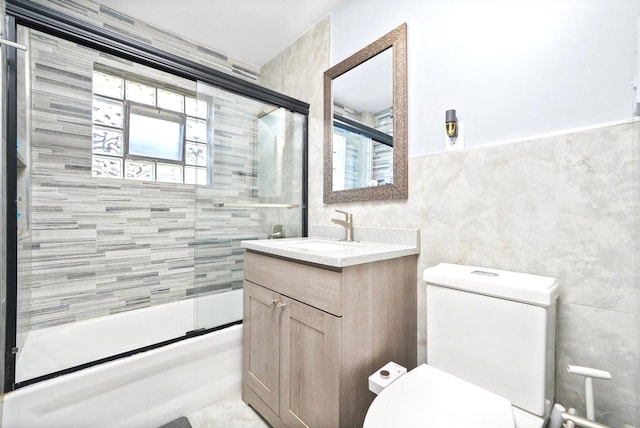 8619 Crawford Ave, Skokie, IL 60076 - full bath with tile walls, toilet, combined bath / shower with glass door, and vanity