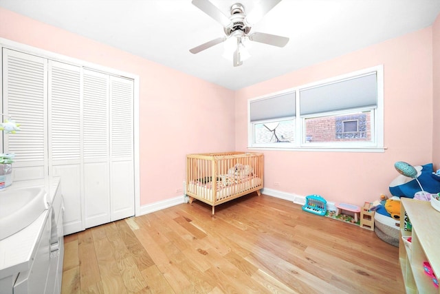 8619 Crawford Ave, Skokie, IL 60076 - bedroom featuring light wood-type flooring, baseboards, a closet, a nursery area, and a sink