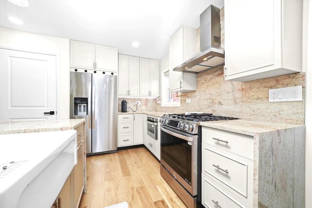 8619 Crawford Ave, Skokie, IL 60076 - kitchen with stainless steel appliances, wall chimney exhaust hood, light wood-style flooring, and white cabinetry