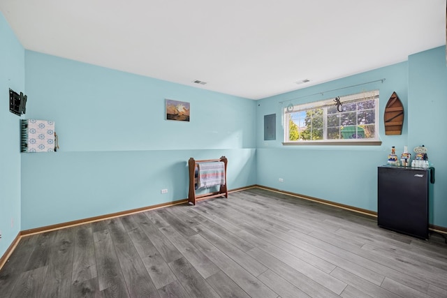 596 N Triumph Ct, Hainesville, IL 60073 - empty room with wood finished floors, electric panel, and baseboards