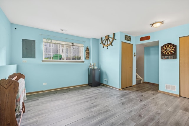 596 N Triumph Ct, Hainesville, IL 60073 - empty room featuring electric panel, wood finished floors, stairs, and baseboards