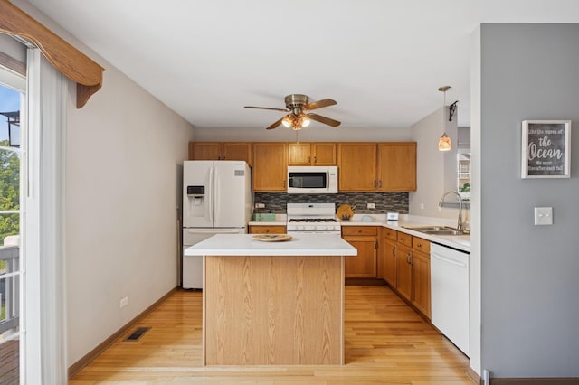 596 N Triumph Ct, Hainesville, IL 60073 - kitchen featuring white appliances, a sink, a ceiling fan, light wood-style floors, and tasteful backsplash