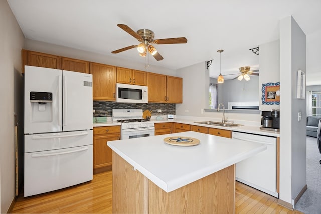 596 N Triumph Ct, Hainesville, IL 60073 - kitchen with white appliances, a sink, ceiling fan, light wood finished floors, and light countertops