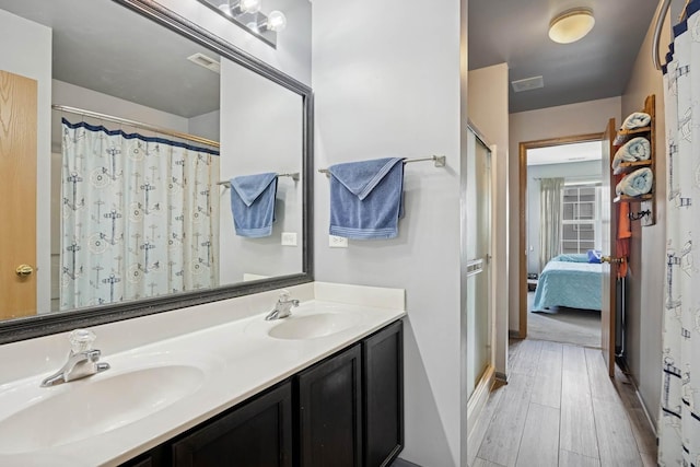 596 N Triumph Ct, Hainesville, IL 60073 - bathroom with wood finished floors, double vanity, connected bathroom, and a shower with curtain