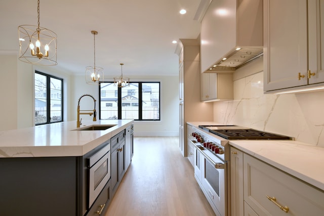 135 Lincoln St, Glenview, IL 60025 - kitchen featuring stainless steel appliances, wall chimney exhaust hood, a sink, a chandelier, and recessed lighting