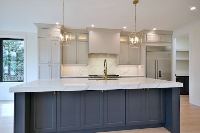 135 Lincoln St, Glenview, IL 60025 - kitchen featuring a chandelier, built in refrigerator, recessed lighting, a large island with sink, and backsplash