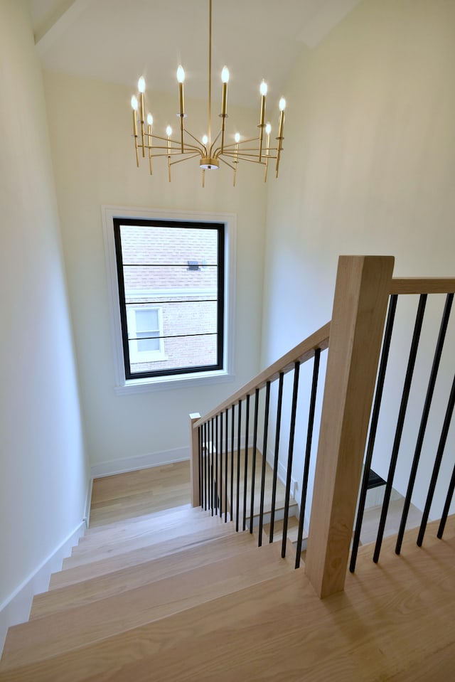 135 Lincoln St, Glenview, IL 60025 - staircase with a chandelier, wood finished floors, and lofted ceiling
