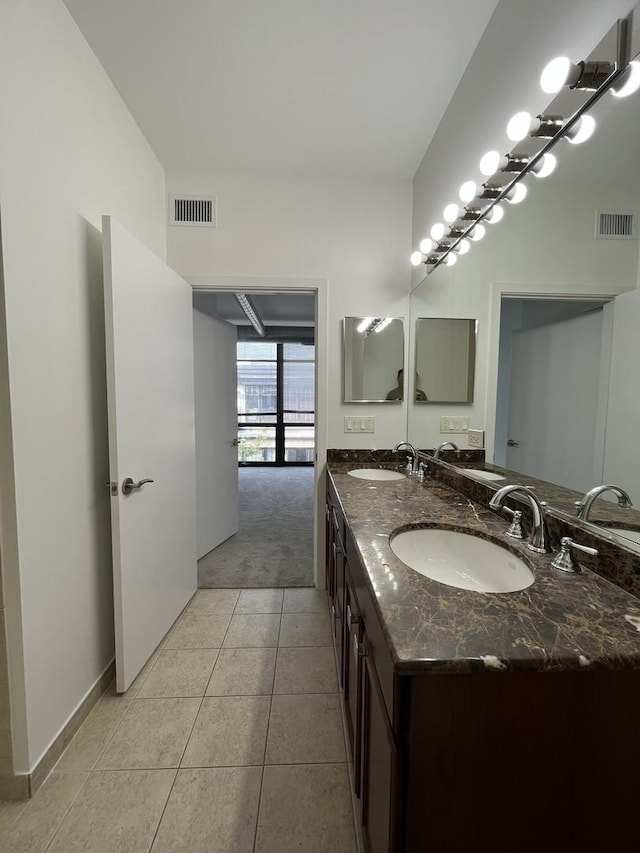 1150 W 15th St Unit 401, Chicago, IL 60608 - bathroom with tile patterned floors, double vanity, and baseboards