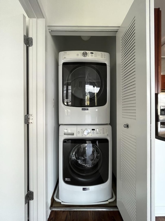 1150 W 15th St Unit 401, Chicago, IL 60608 - laundry room with stacked washing machine and dryer and wood finished floors