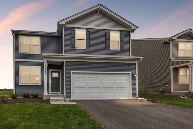 2461 Tahoe Ln, Pingree Grove, IL 60140 - traditional-style home featuring an attached garage, asphalt driveway, and a front yard