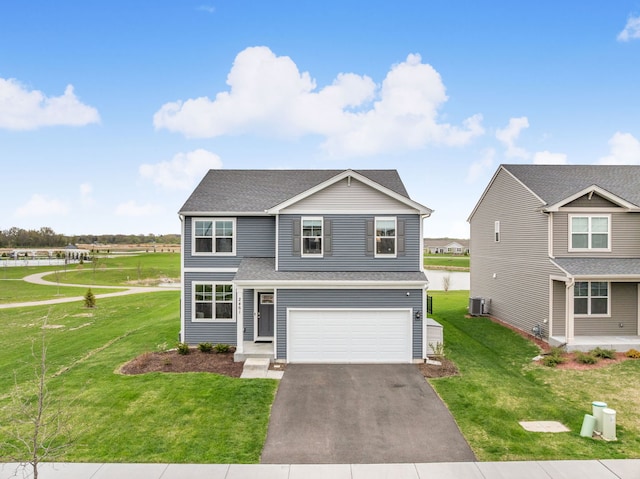 2461 Tahoe Ln, Pingree Grove, IL 60140 - traditional home featuring an attached garage, asphalt driveway, a front lawn, and a shingled roof