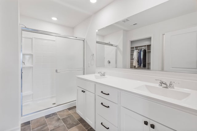 2461 Tahoe Ln, Pingree Grove, IL 60140 - full bathroom with a shower stall, a walk in closet, double vanity, recessed lighting, and stone finish floors