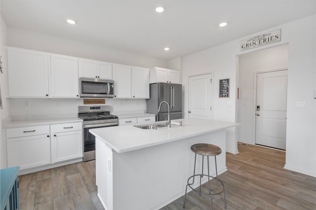 2461 Tahoe Ln, Pingree Grove, IL 60140 - kitchen with appliances with stainless steel finishes, a sink, white cabinetry, a center island with sink, and recessed lighting