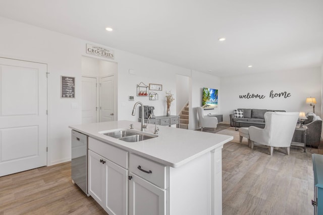 2461 Tahoe Ln, Pingree Grove, IL 60140 - kitchen featuring a sink, stainless steel dishwasher, light countertops, white cabinetry, and light wood-style flooring