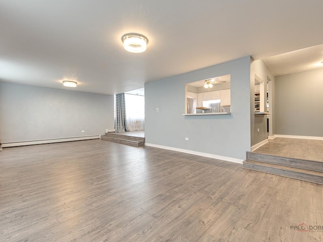 8801 W Golf Rd Unit 6J, Niles, IL 60714 - unfurnished living room with wood finished floors, a baseboard radiator, baseboards, and ceiling fan