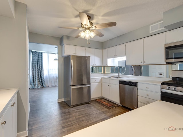 8801 W Golf Rd Unit 6J, Niles, IL 60714 - kitchen with appliances with stainless steel finishes, a ceiling fan, dark wood finished floors, light countertops, and white cabinetry