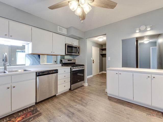 8801 W Golf Rd Unit 6J, Niles, IL 60714 - kitchen with appliances with stainless steel finishes, a sink, a ceiling fan, light wood-type flooring, and light countertops