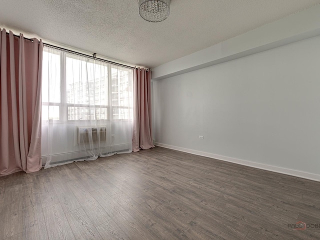 8801 W Golf Rd Unit 6J, Niles, IL 60714 - unfurnished room with dark wood-type flooring, a textured ceiling, and baseboards