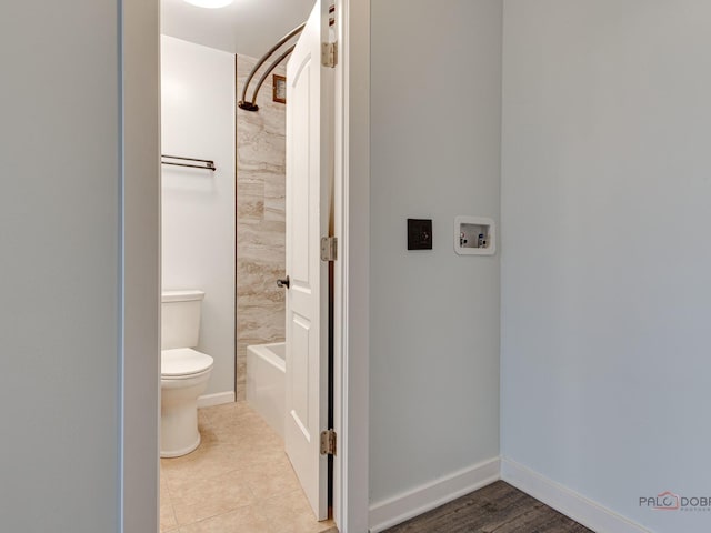 8801 W Golf Rd Unit 6J, Niles, IL 60714 - bathroom featuring toilet, bathing tub / shower combination, and baseboards