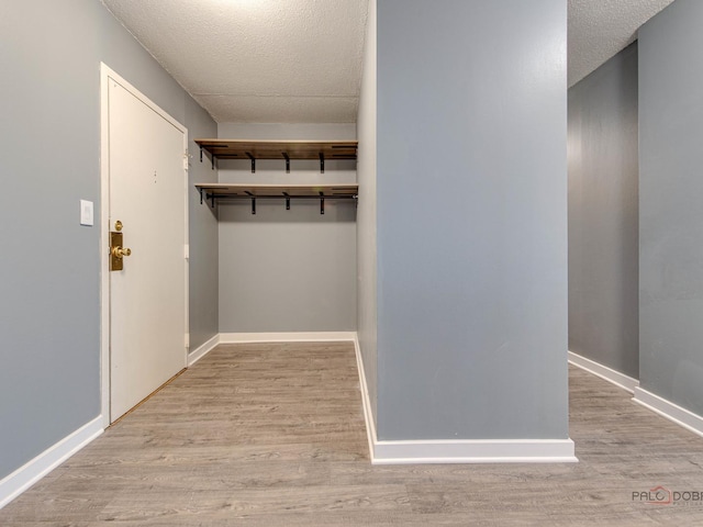 8801 W Golf Rd Unit 6J, Niles, IL 60714 - mudroom with wood finished floors, a textured ceiling, and baseboards