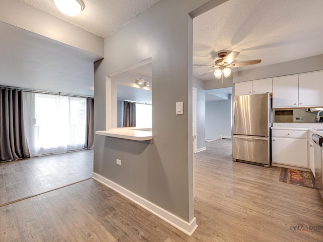 8801 W Golf Rd Unit 6J, Niles, IL 60714 - kitchen featuring freestanding refrigerator, a ceiling fan, a textured ceiling, baseboards, and light wood finished floors