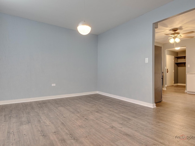 8801 W Golf Rd Unit 6J, Niles, IL 60714 - empty room featuring ceiling fan, wood finished floors, and baseboards
