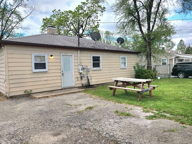 back of property with a chimney