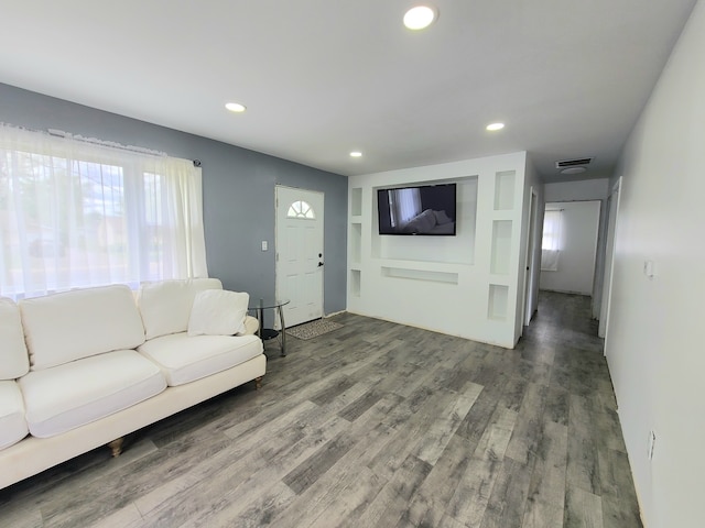 living area featuring wood finished floors and recessed lighting