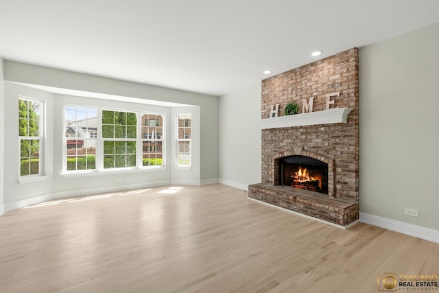 23653 W Ewing Dr, Plainfield, IL 60586 - unfurnished living room featuring a fireplace, light wood finished floors, baseboards, and recessed lighting