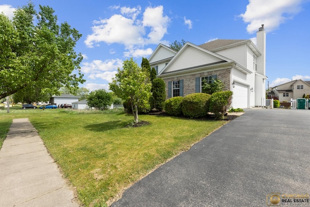 23653 W Ewing Dr, Plainfield, IL 60586 - view of front of home featuring asphalt driveway, an attached garage, a front yard, a chimney, and brick siding