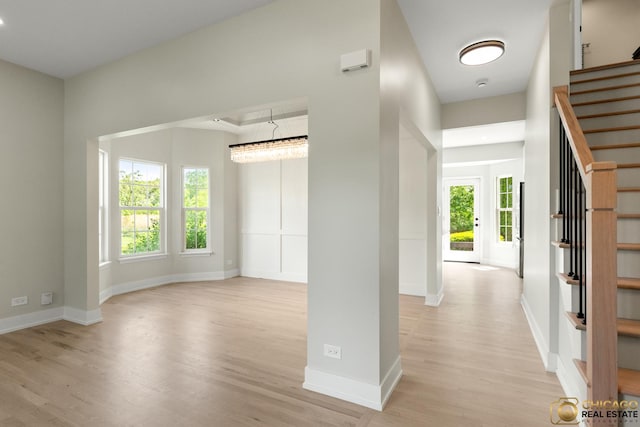 23653 W Ewing Dr, Plainfield, IL 60586 - foyer with light wood-type flooring, stairway, and baseboards