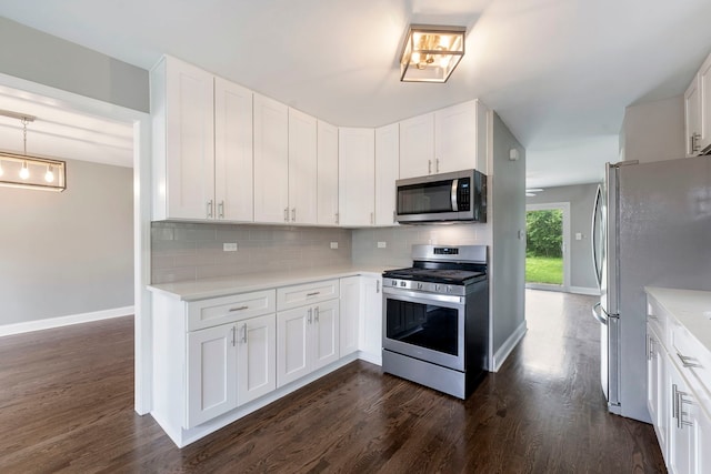 666 Barberry Rd, Highland Park, IL 60035 - kitchen with appliances with stainless steel finishes, backsplash, baseboards, light countertops, and dark wood-style flooring