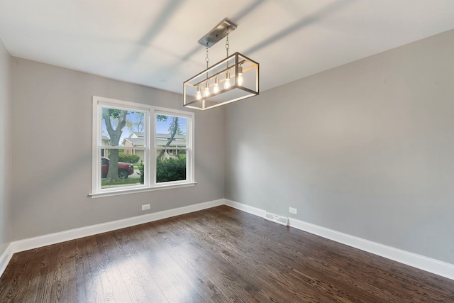 666 Barberry Rd, Highland Park, IL 60035 - empty room featuring a chandelier, baseboards, and dark wood finished floors